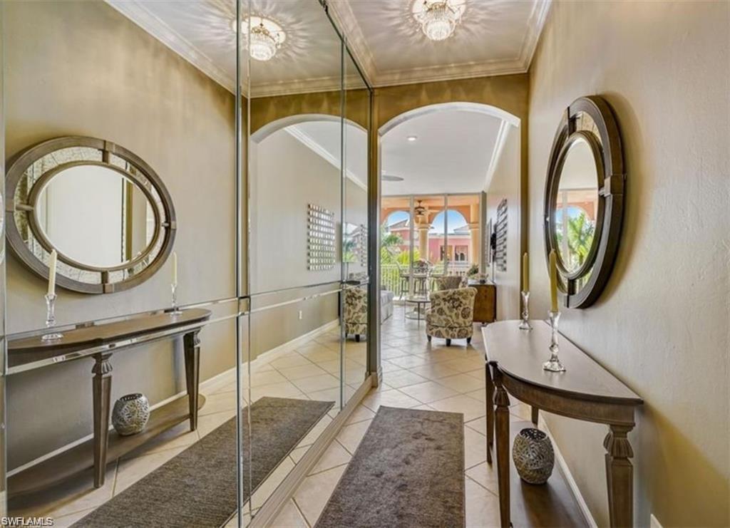 450 Bayfront Place, Unit 4502 Naples, FL 34102 - Photo 11 of 11 a living room with a mirror and a chandelier