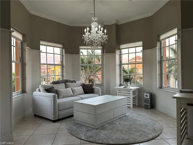 a living room with furniture and a chandelier