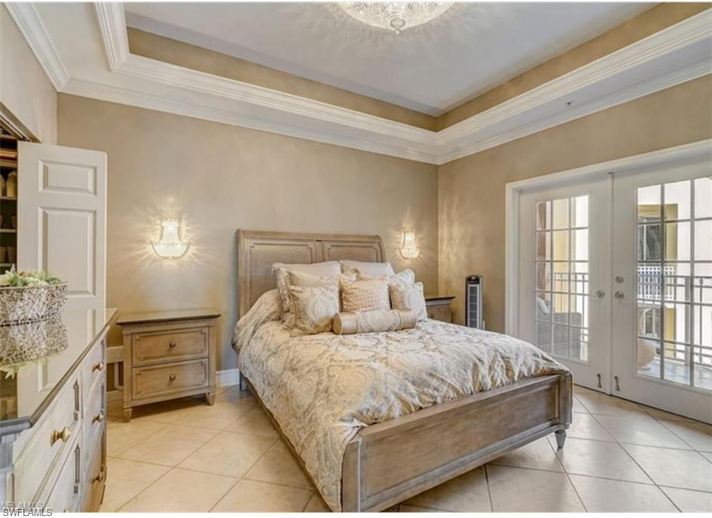 450 Bayfront Place, Unit 4502 Naples, FL 34102 - Photo 8 of 11 a bedroom with a bed and a night stand