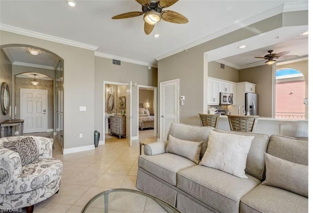 450 Bayfront Place, Unit 4502 Naples, FL 34102 - Photo 9 of 11 a living room with furniture and a large mirror