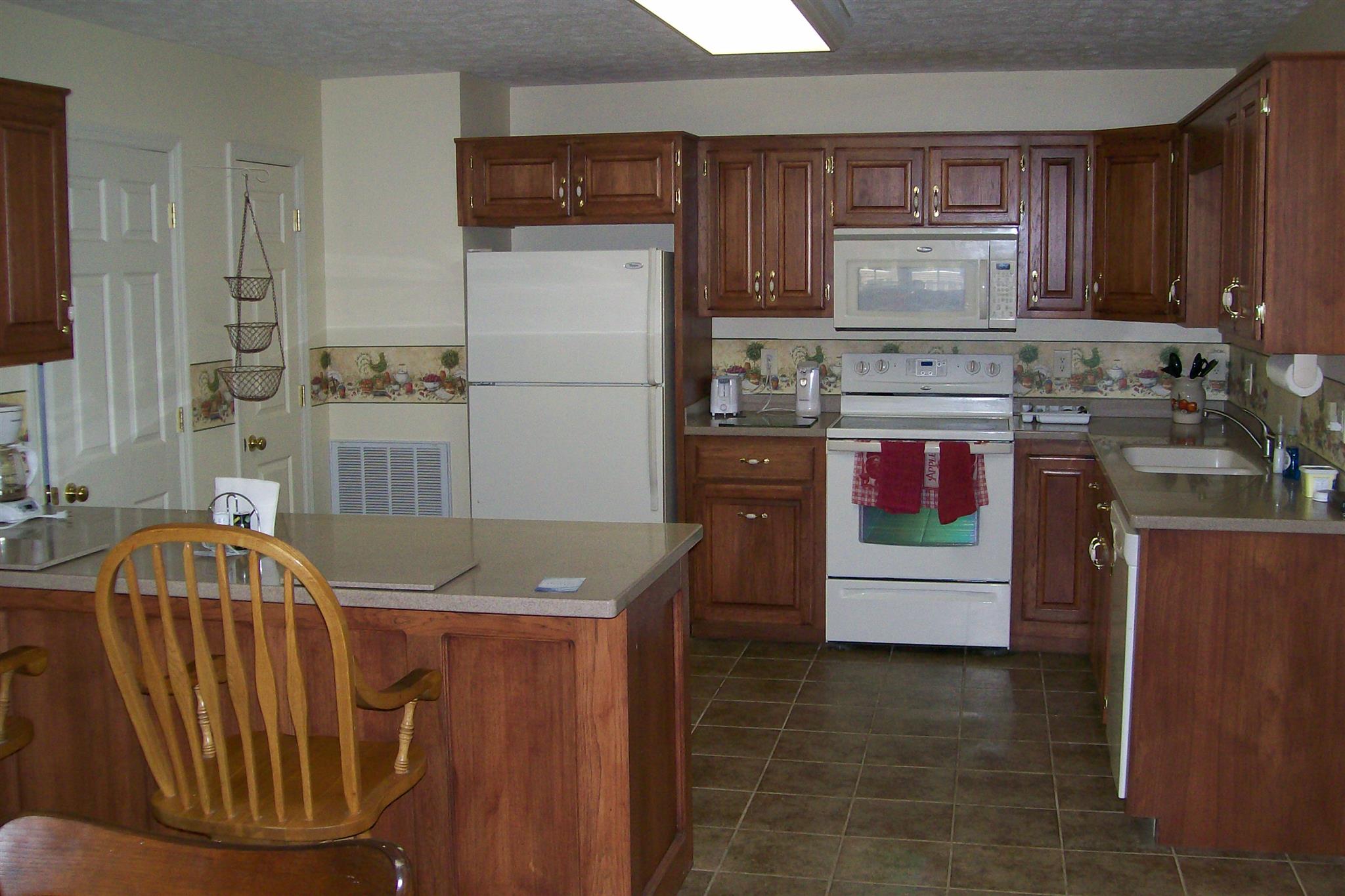 10748 Harrison Ferry Road McMinnville, TN 37110 - Photo 15 of 29 a kitchen with refrigerator and cabinets