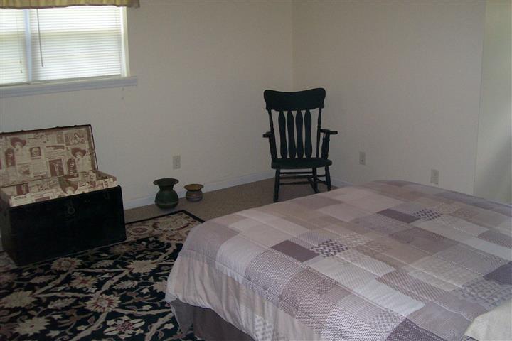 10748 Harrison Ferry Road McMinnville, TN 37110 - Photo 27 of 29 a bedroom with a bed and wooden floor