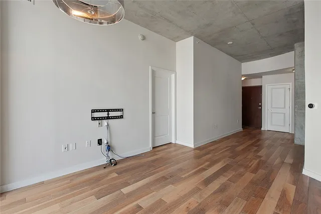 a view of a room with wooden floor