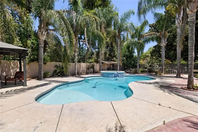 a view of a house with swimming pool and sitting area