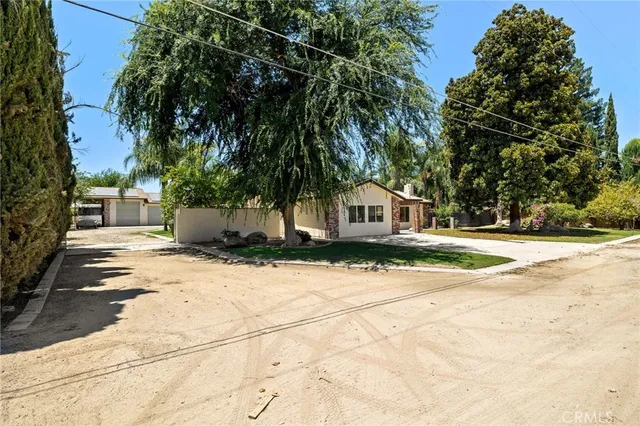 a view of a house with a yard and a garage