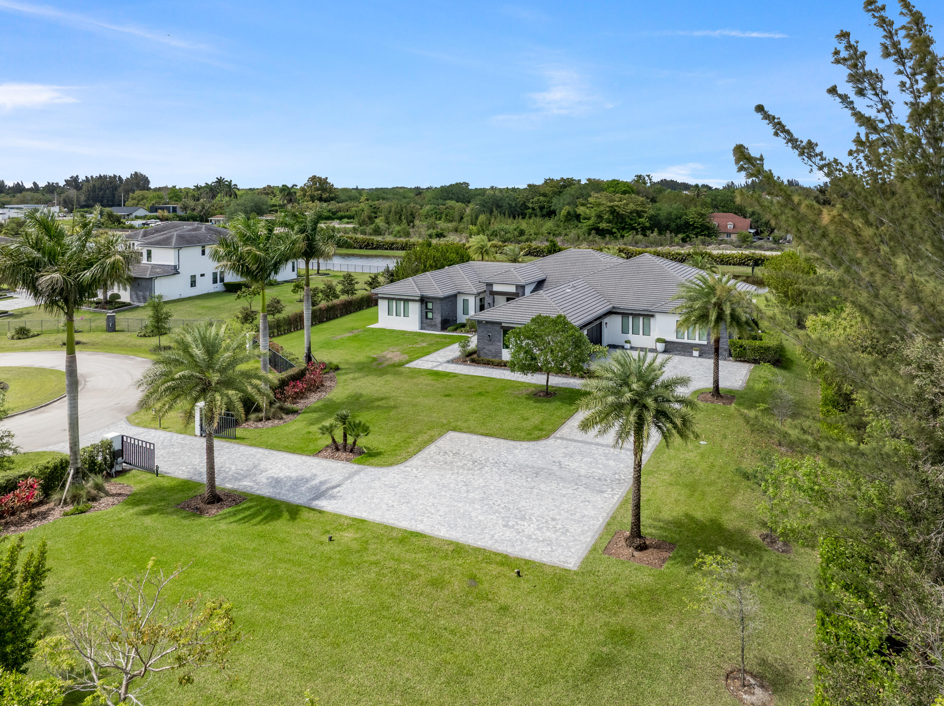 17101 Magnolia Estates Drive Southwest Ranches, FL 33331 - Photo 2 of 57 an aerial view of residential houses with outdoor space and trees