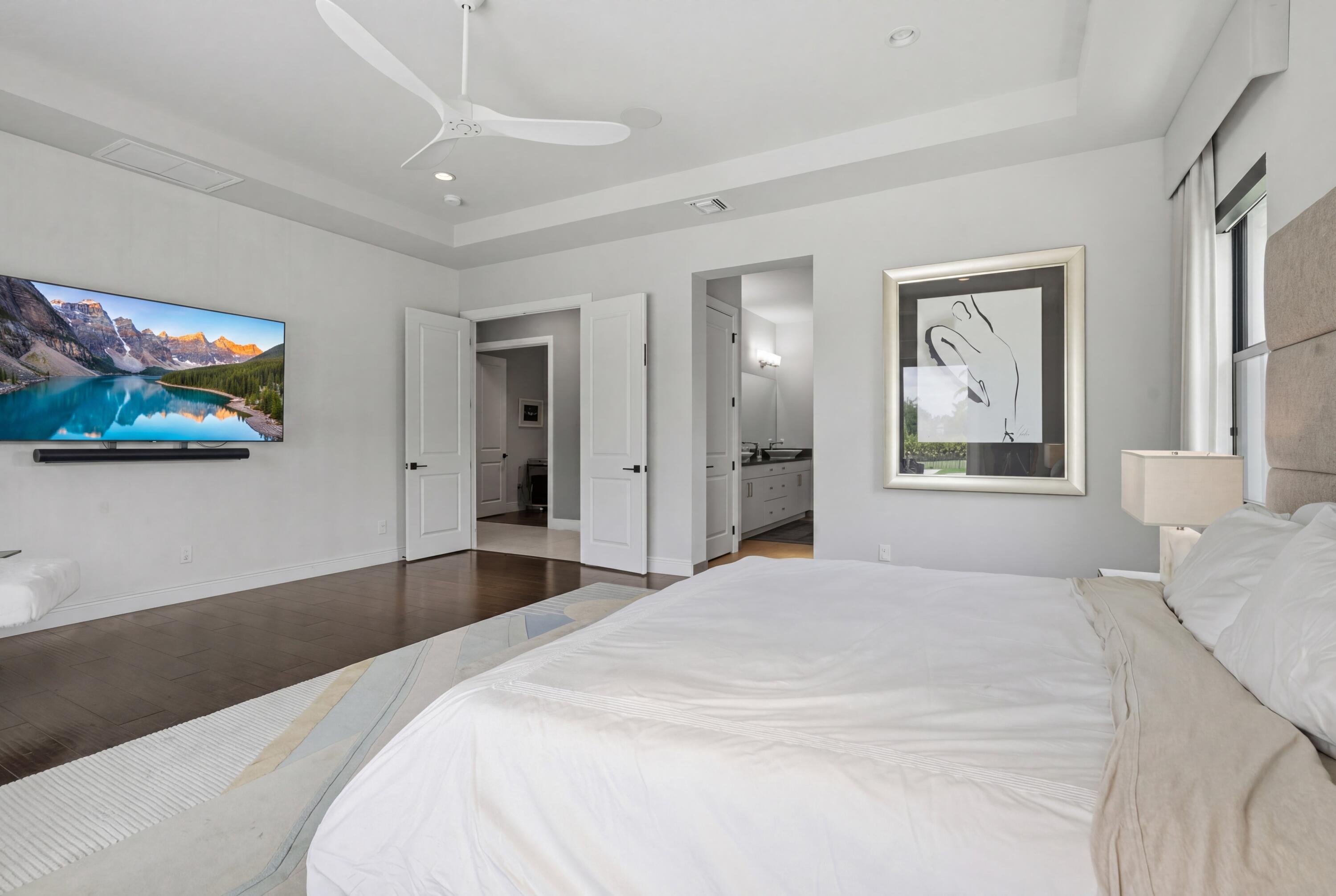 17101 Magnolia Estates Drive Southwest Ranches, FL 33331 - Photo 21 of 57 a bedroom with a large bed and a chandelier