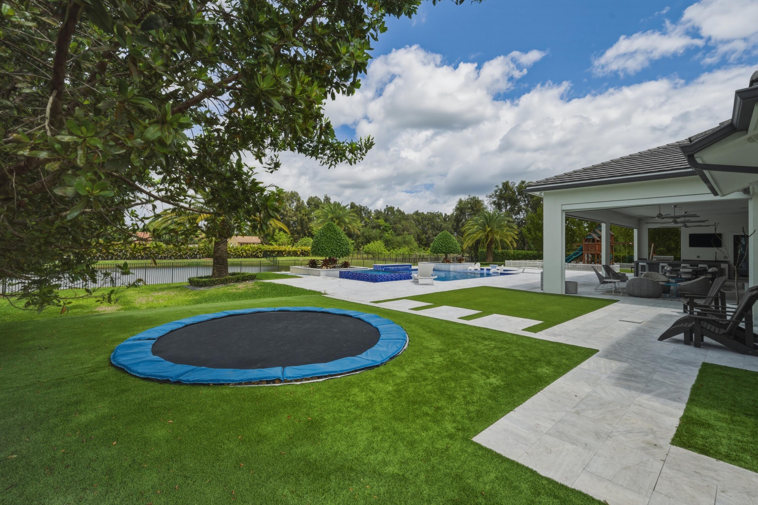 17101 Magnolia Estates Drive Southwest Ranches, FL 33331 - Photo 49 of 57 a view of a swimming pool with a yard