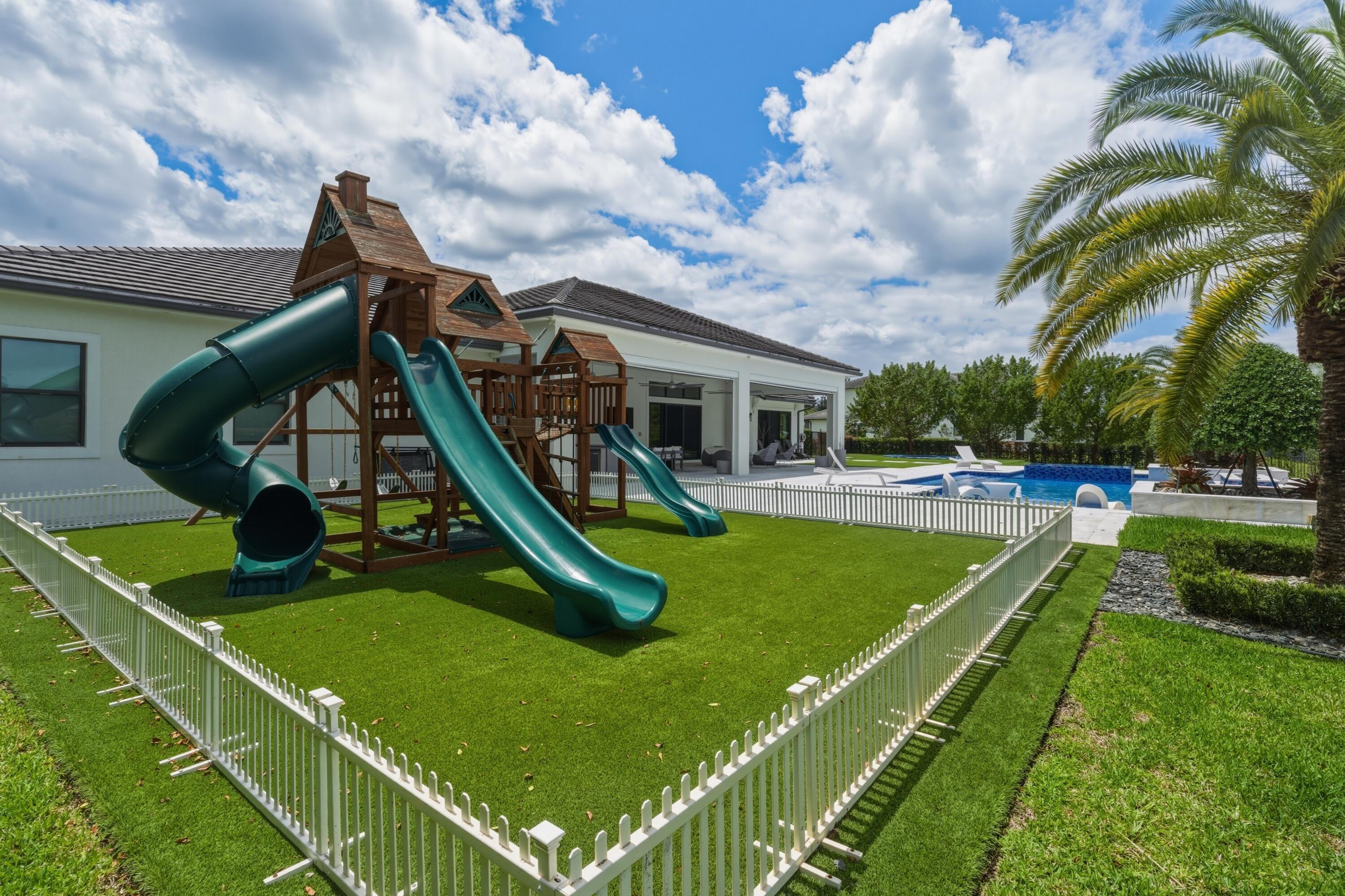 17101 Magnolia Estates Drive Southwest Ranches, FL 33331 - Photo 51 of 57 a view of a swimming pool with a garden and plants