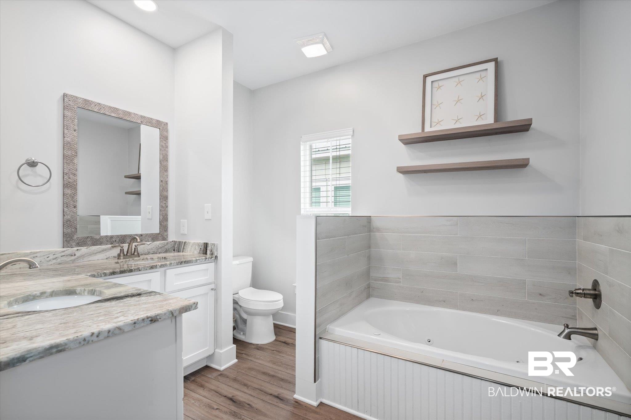8056 Carmel Circle Foley, AL 36535 - Photo 15 of 28 Bathroom with vanity, toilet, a bathing tub, and hardwood / wood-style floors