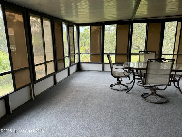 a view of hall with furniture and windows