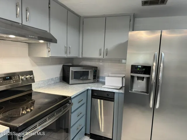 a kitchen with a refrigerator stove and microwave