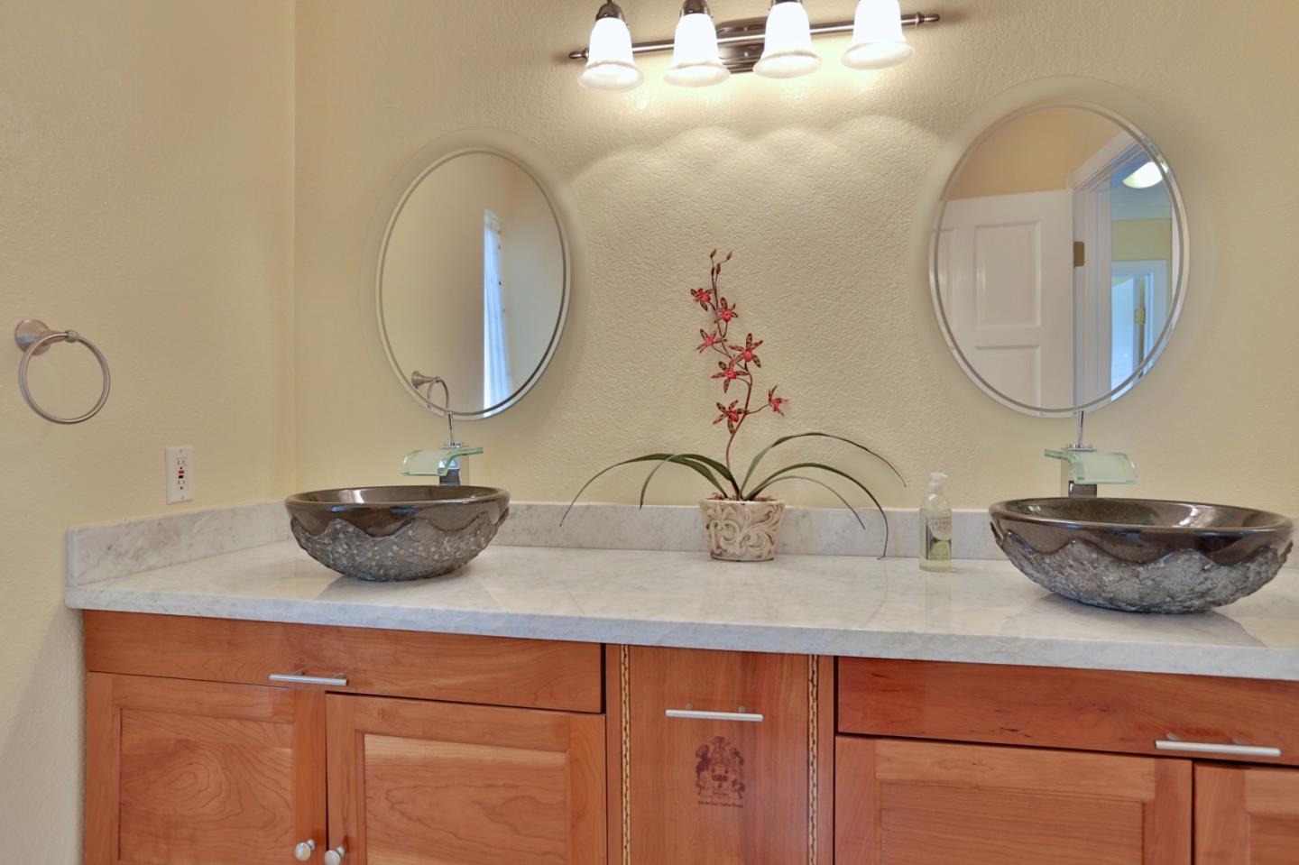 9040 El Matador Drive Gilroy, CA 95020 - Photo 18 of 26 a bathroom with a granite countertop sink and a mirror