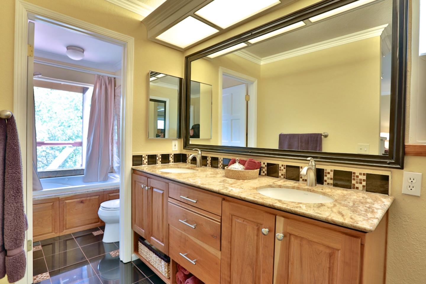 9040 El Matador Drive Gilroy, CA 95020 - Photo 20 of 26 a bathroom with a granite countertop sink a toilet and a large mirror