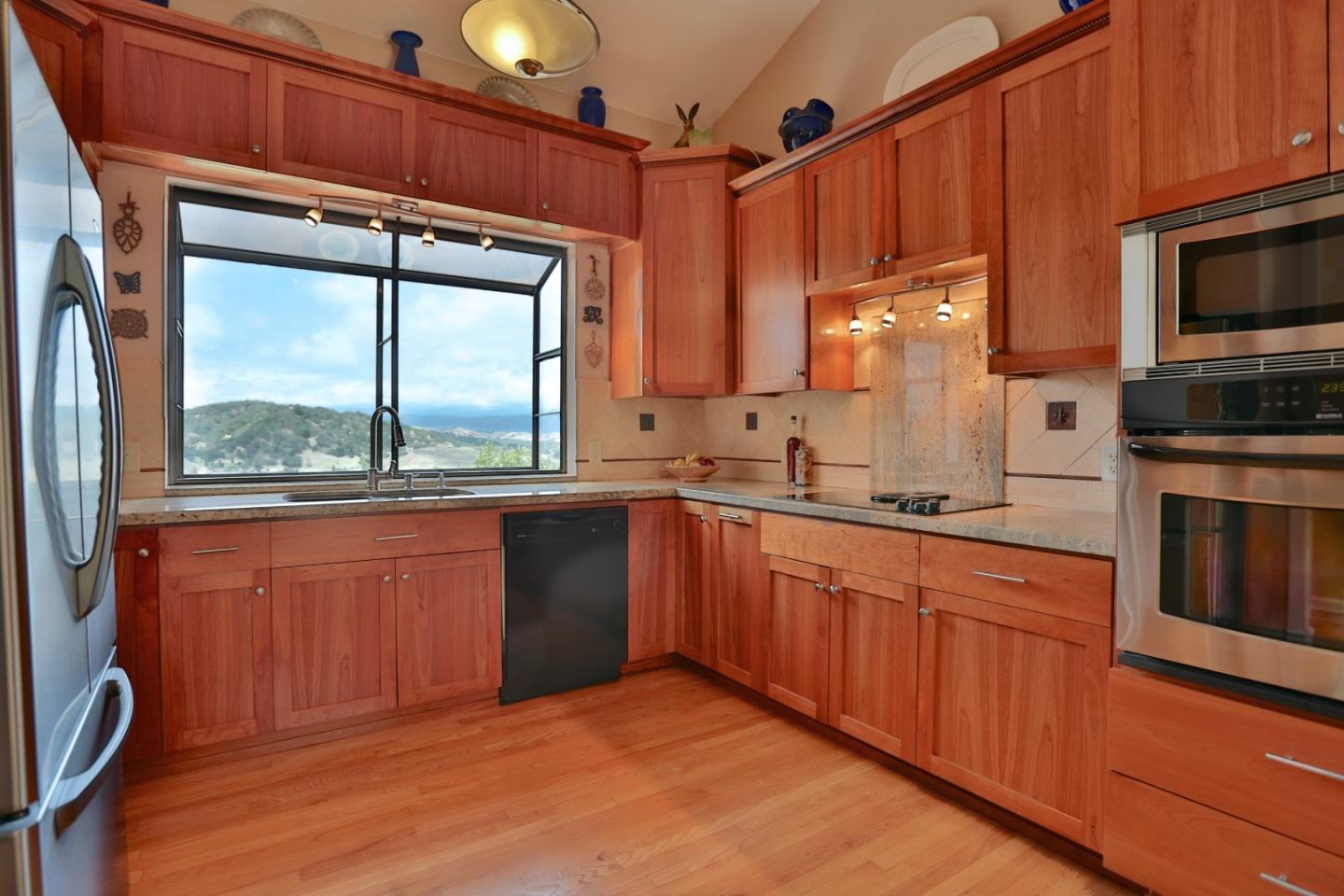 9040 El Matador Drive Gilroy, CA 95020 - Photo 5 of 26 a kitchen with stainless steel appliances granite countertop a refrigerator a sink dishwasher a stove and a microwave oven with cabinets