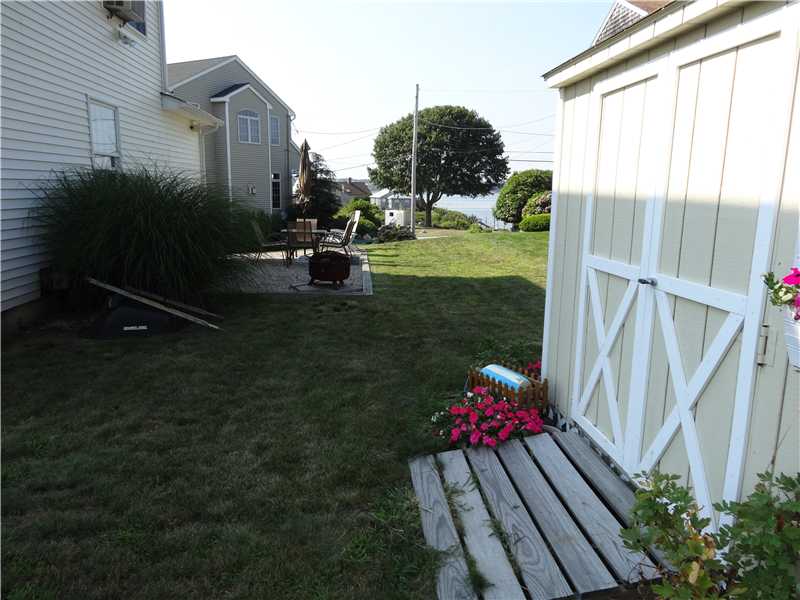 16 Abalone Road Narragansett, RI 02882 - Photo 14 of 18 Exterior Back. outside shed,stone patio with waterviews