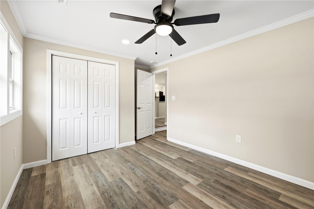 418 Old River Road Pelzer, SC 29669 - Photo 19 of 29 A quiet bedroom featuring elegant wood plank flooring and a functional ceiling fan, offering a comfortable personal retreat.