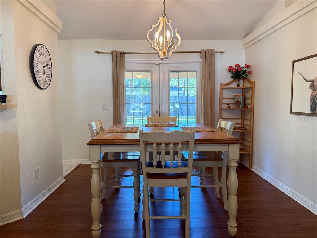 6470 Northwest 56th Terrace Ocala, FL 34482 - Photo 11 of 34 a view of a dining room with furniture window and wooden floor