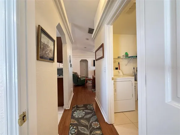 a bedroom with a bed and a dresser with rug