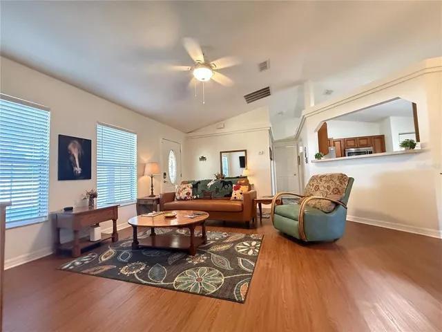 a living room with furniture rug and wooden floor