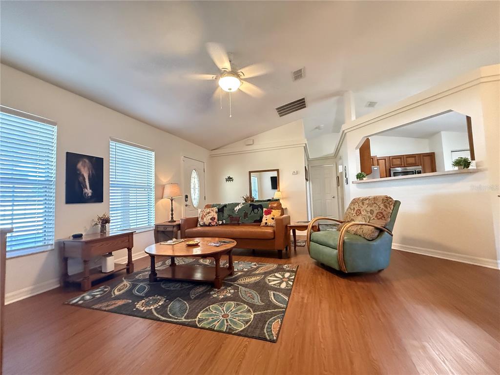 6470 Northwest 56th Terrace Ocala, FL 34482 - Photo 4 of 34 a living room with furniture rug and wooden floor