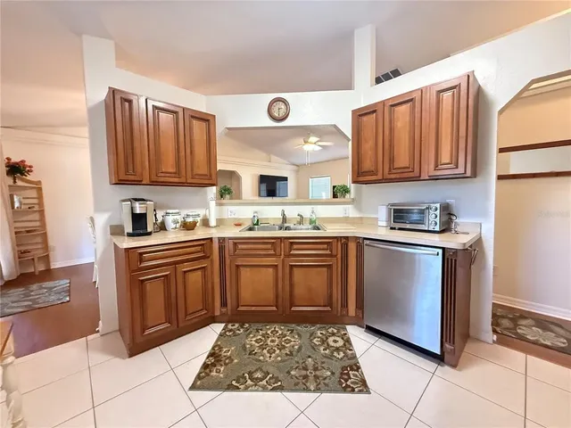a kitchen with a sink window and cabinets