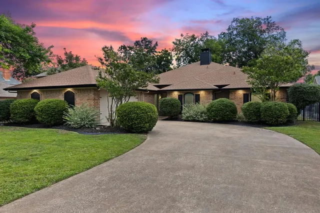 a house with green field in front of it
