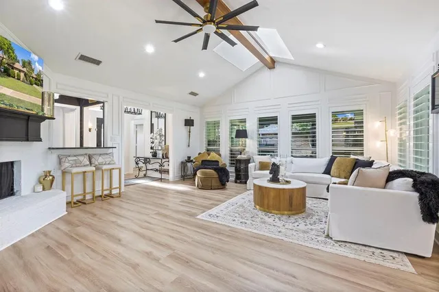 a living room with furniture a fireplace and a flat screen tv