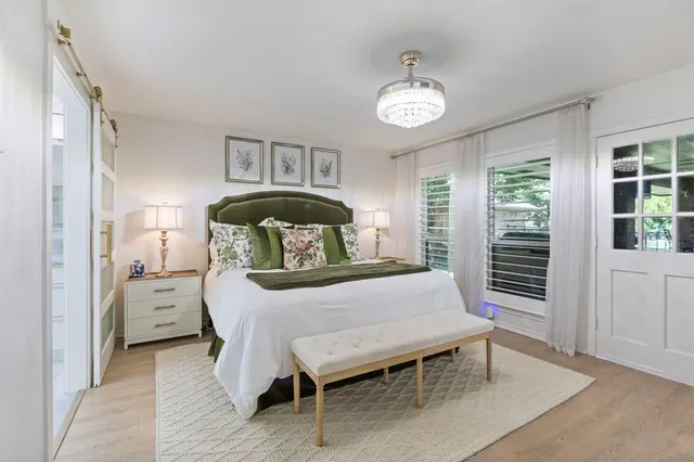 a bedroom with a bed and a chandelier