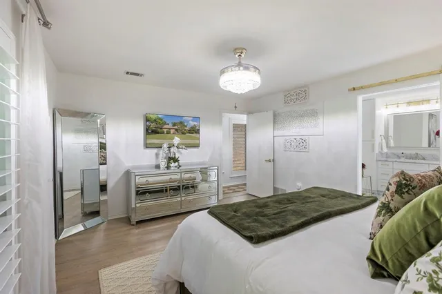 a bedroom with a bed and a chandelier