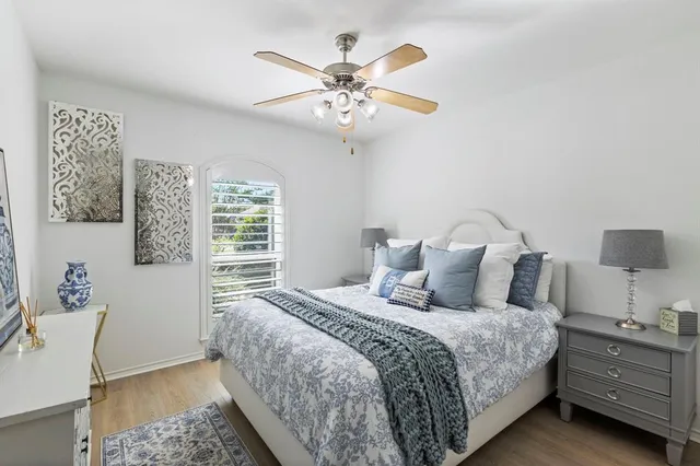 a bedroom with a large bed and a chandelier