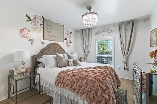 a bedroom with a bed and a chandelier