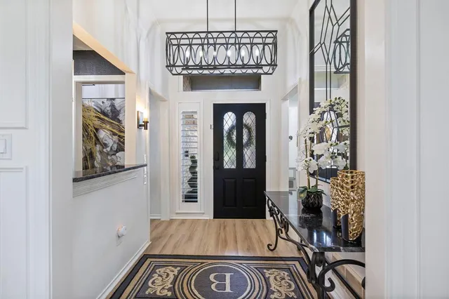 a view of an entryway with wooden floor