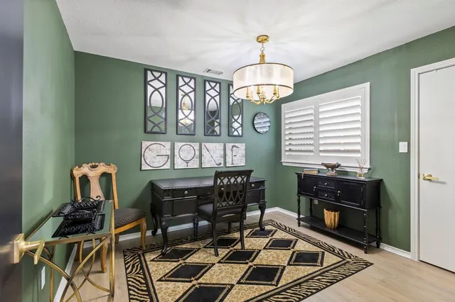 a view of a dining room with furniture a chandelier and wooden floor