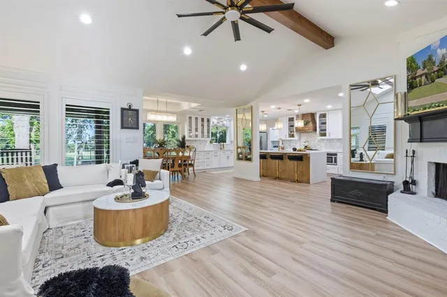 a living room with furniture and a view of kitchen