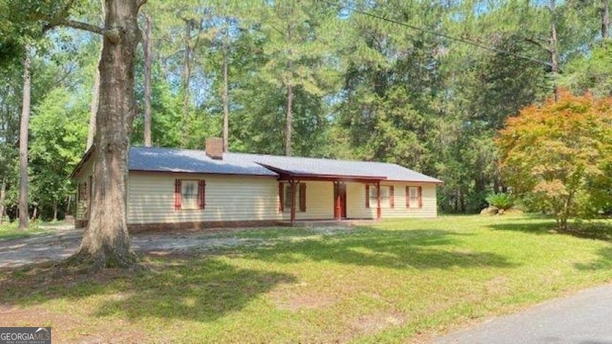 2006 Cleveland Street Vidalia, GA 30474 - Photo 1 of 1 a front view of a house with a yard