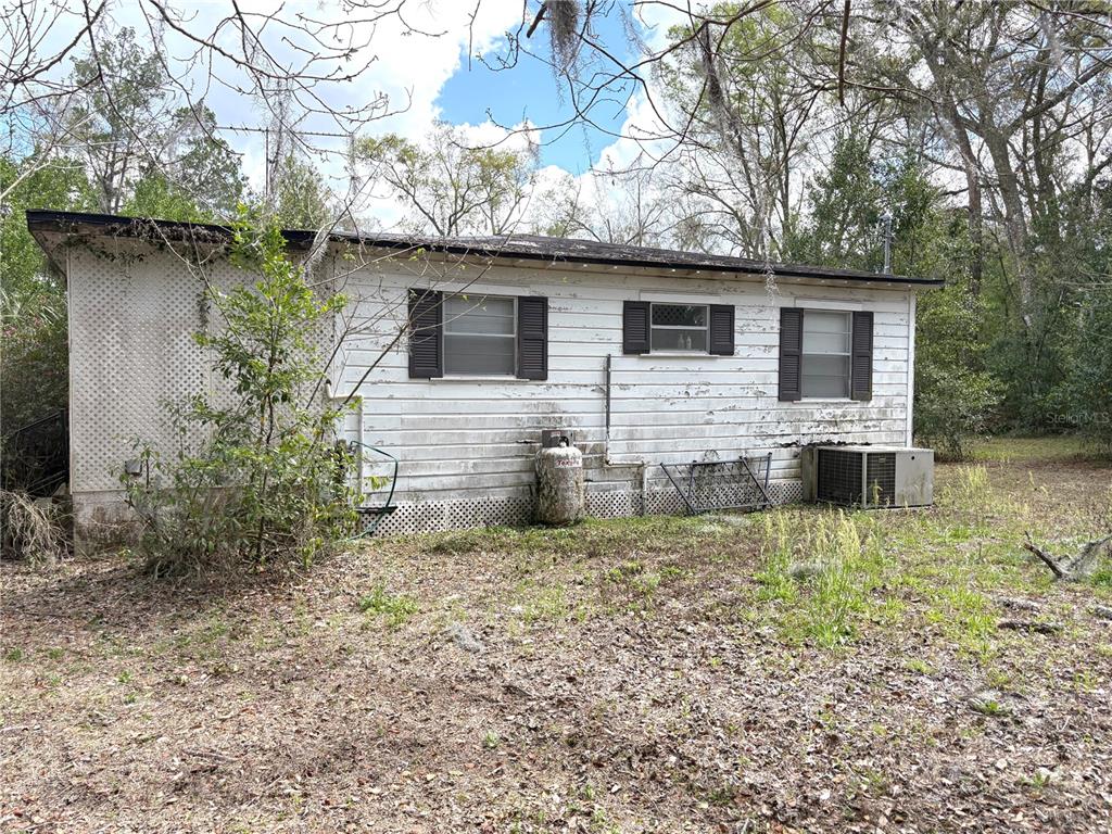21249 Durden Road Dade City, FL 33523 - Photo 17 of 28 a view of a house with a yard