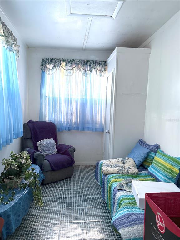 21249 Durden Road Dade City, FL 33523 - Photo 5 of 28 a bedroom with bed and a couch