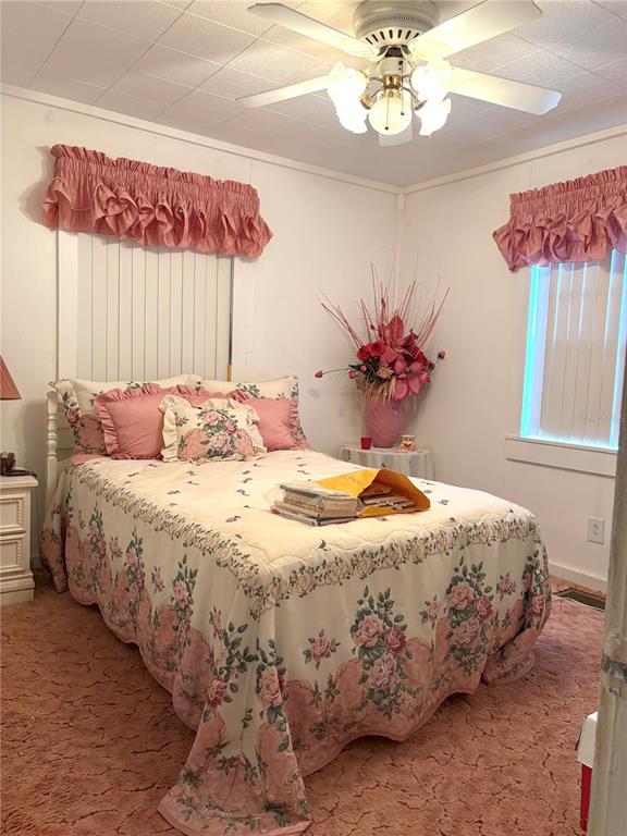 21249 Durden Road Dade City, FL 33523 - Photo 6 of 28 a bedroom with a bed mirror and a window