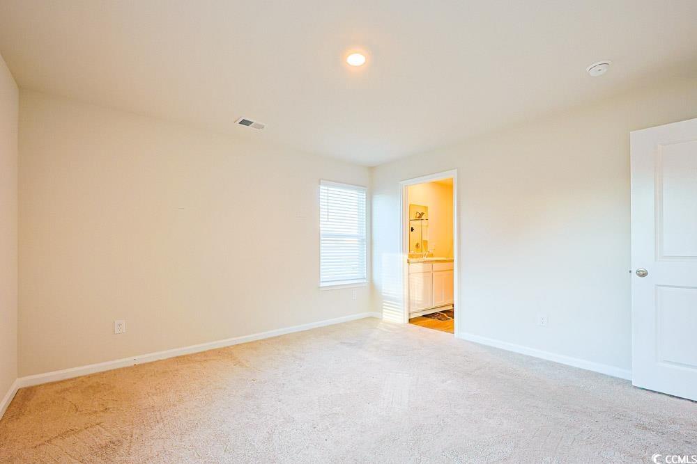 224 Jeff Waters Circle Longs, SC 29568 - Photo 12 of 30 Unfurnished bedroom featuring light colored carpet, ensuite bath, and recessed lighting