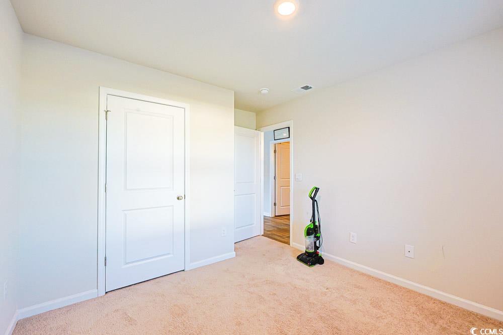224 Jeff Waters Circle Longs, SC 29568 - Photo 15 of 30 Unfurnished bedroom with light carpet and recessed lighting