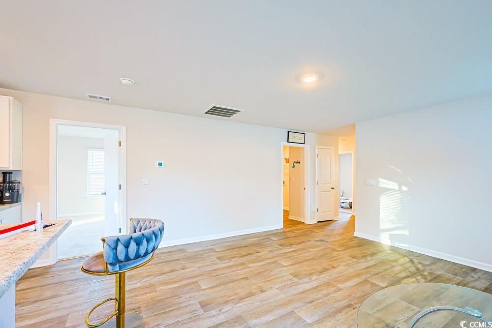 224 Jeff Waters Circle Longs, SC 29568 - Photo 6 of 30 Empty room with light wood finished floors and baseboards
