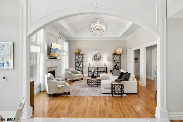 a spacious bedroom with a large bed and a flat tv screen