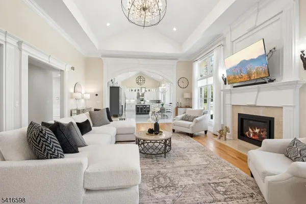 a large white kitchen with cabinets a sink a dining table and chairs