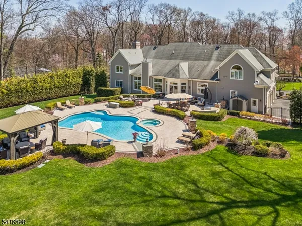 a view of a house with swimming pool and porch