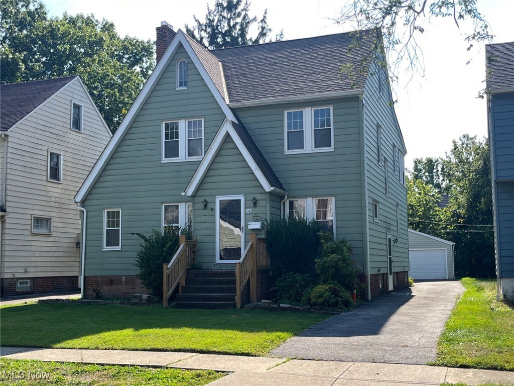 1148 Sylvania Road Cleveland Heights, OH 44121 - Photo 1 of 30 View of front of house with a chimney, a front lawn, and a 2 car garage.