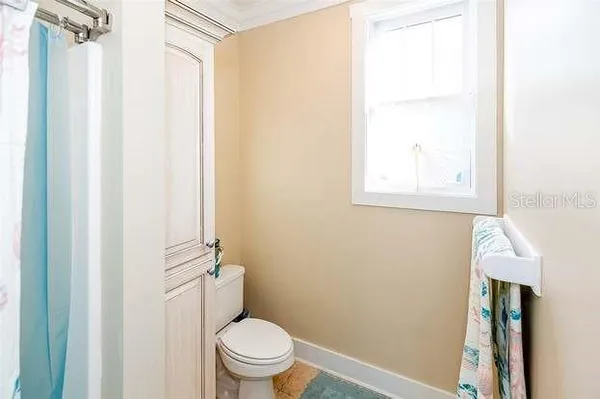 a white toilet sitting next to a bathroom sink