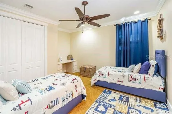 a bedroom with two beds and a window