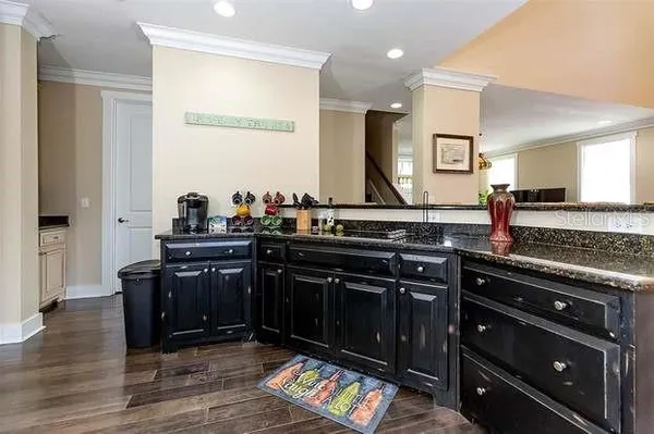 a kitchen with a stove and a wooden floor