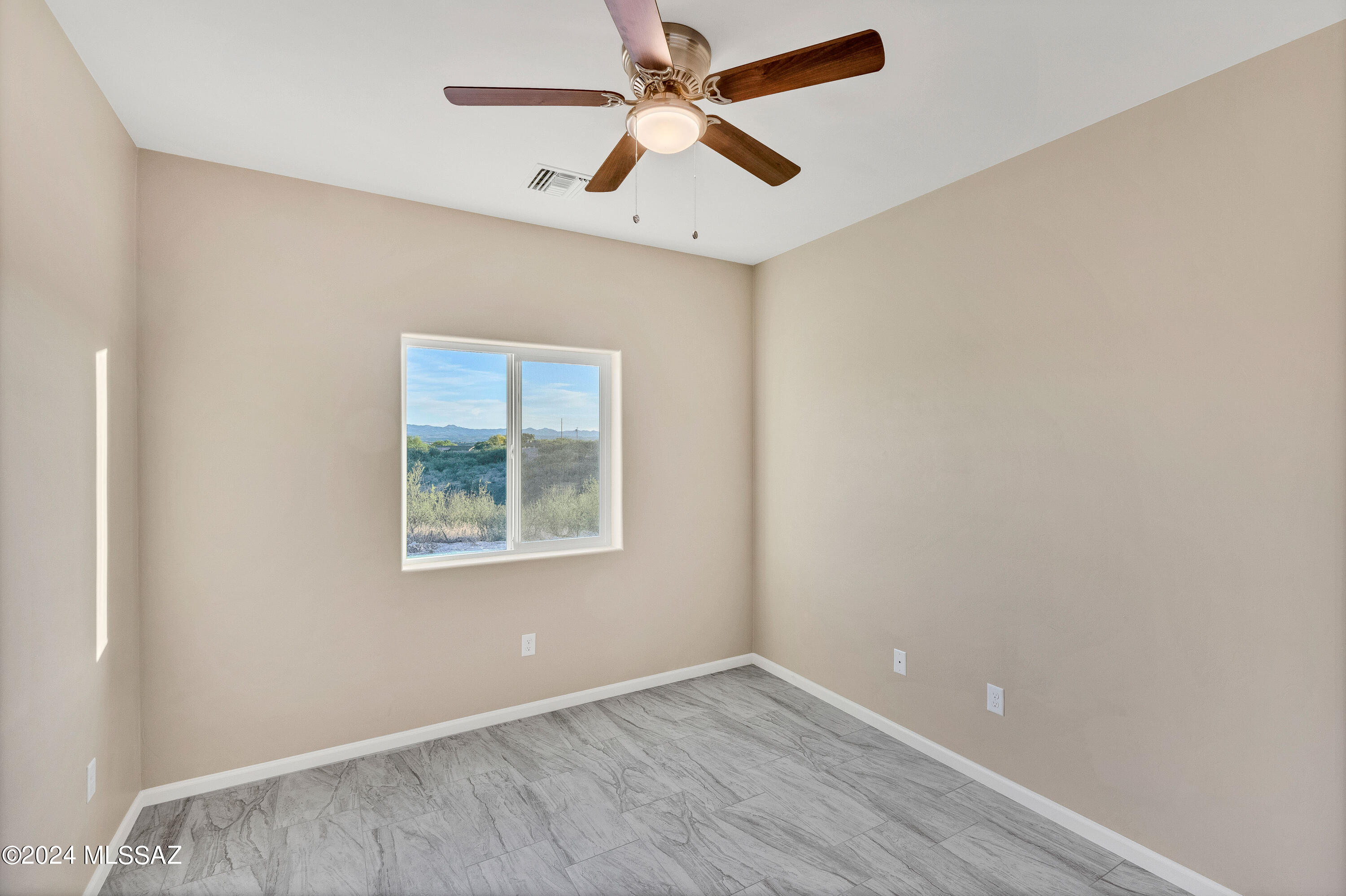 356 Globo Court Rio Rico, AZ 85648 - Photo 25 of 32 an empty room with a window and a fan